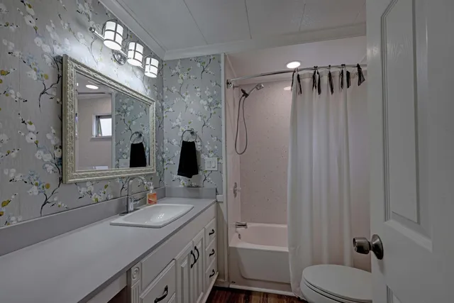 a bathroom with a sink toilet tub and shower
