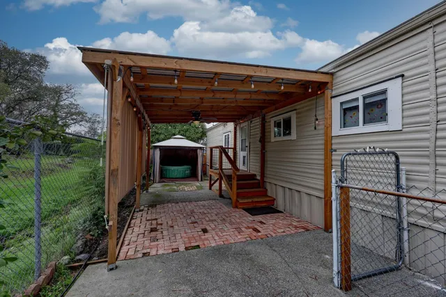 a backyard of a house with barbeque oven table and chairs