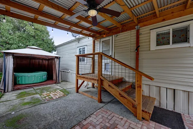a backyard of a house with wooden floor a fire pit and outdoor space