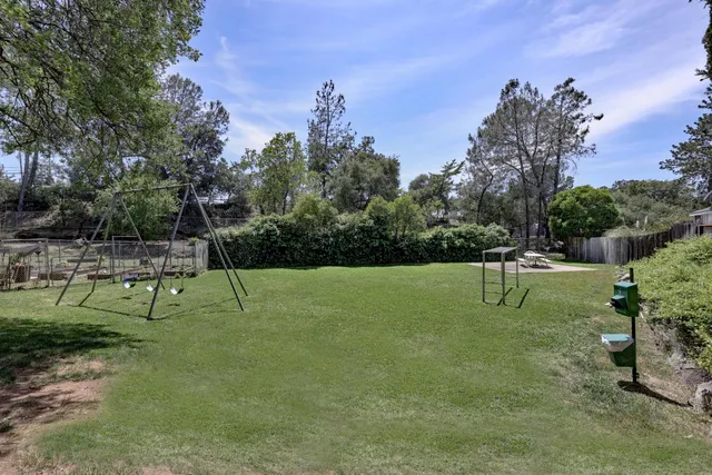 a view of a backyard with sitting area