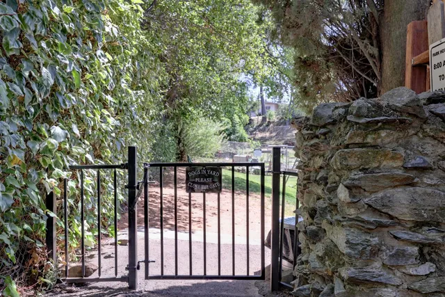 a view of a street with a bench in front of house