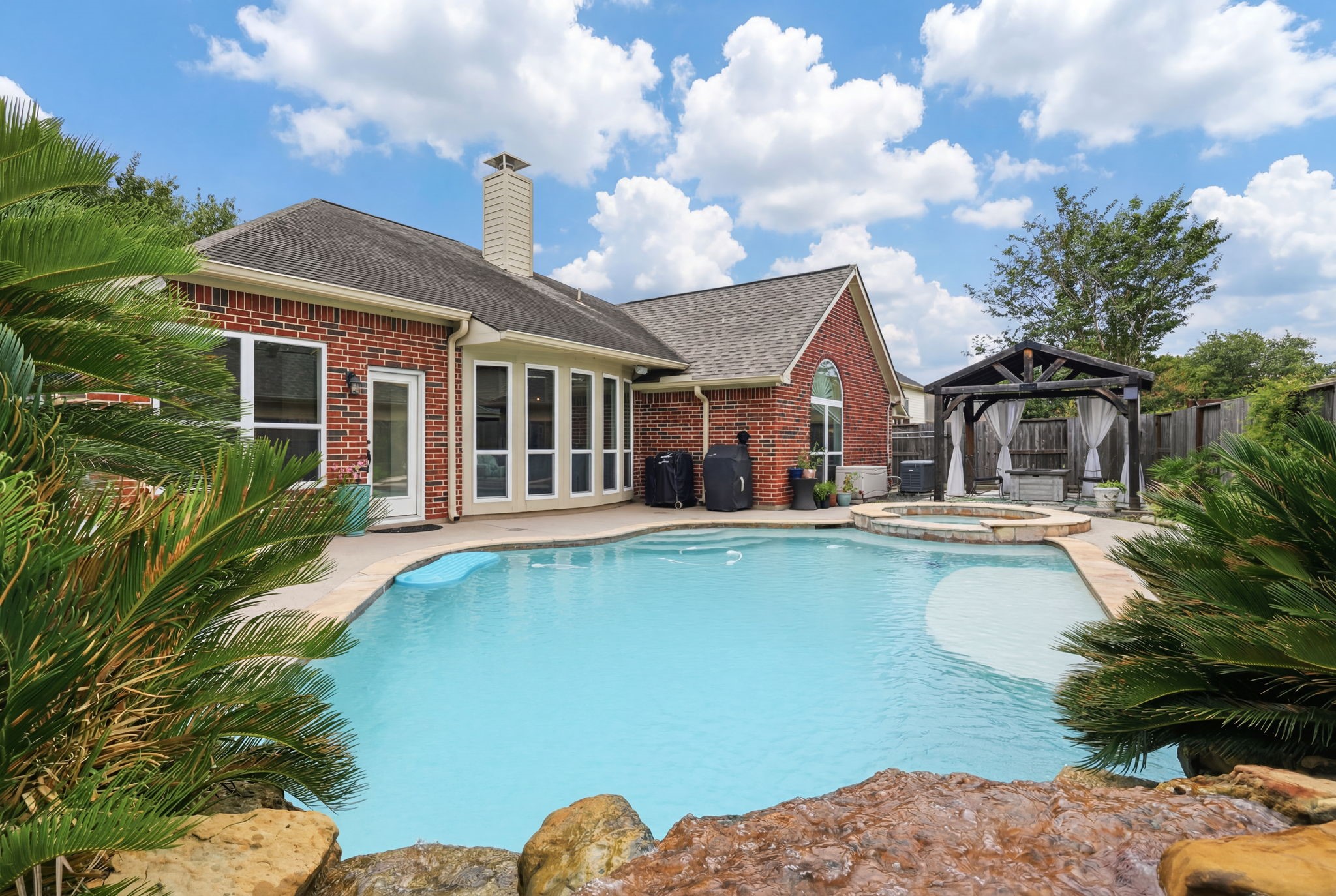 1010 Bringewood Chase Drive Spring, TX 77379 - Photo 1 of 49 Pool with tanning ledge and heated spa and pool. Rock waterfall. Full brick exterior. Generator.