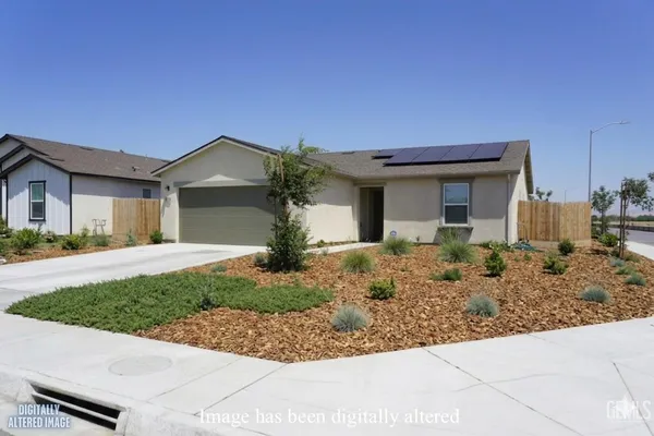 a front view of a house with garage and plants