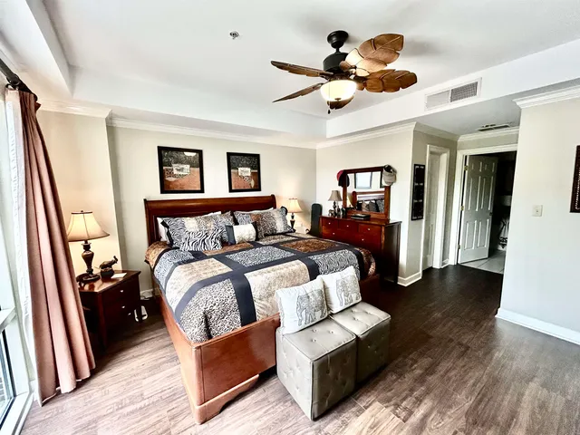 a bedroom with furniture and a large window