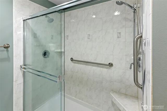 a bathroom with a glass shower door