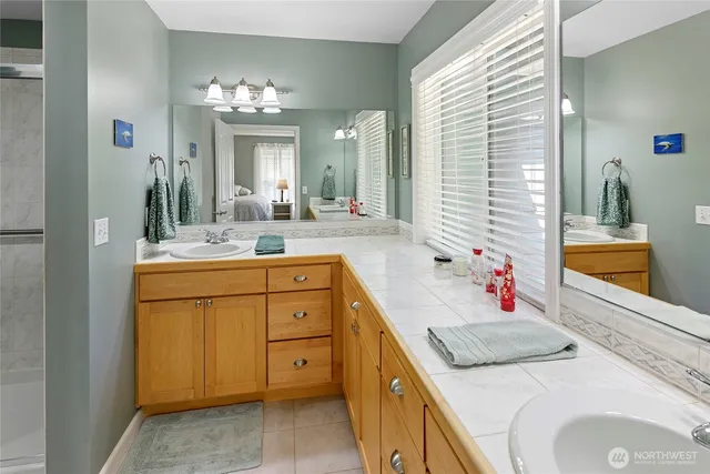 a bathroom with a sink vanity and a mirror