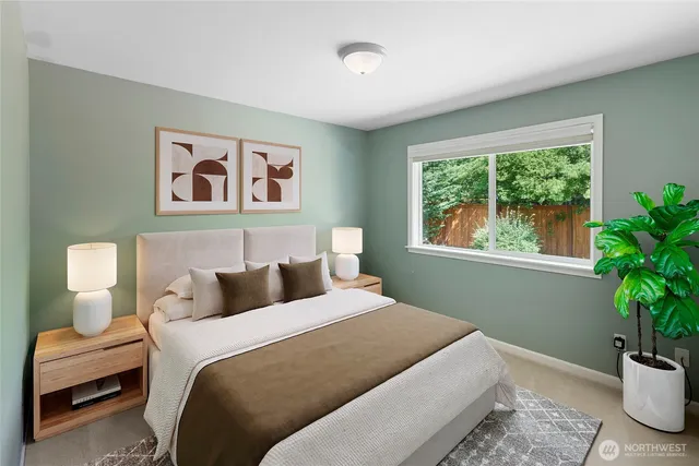 a bedroom with a large bed and a potted plant
