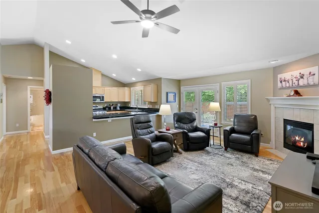 a living room with furniture kitchen view and a fireplace