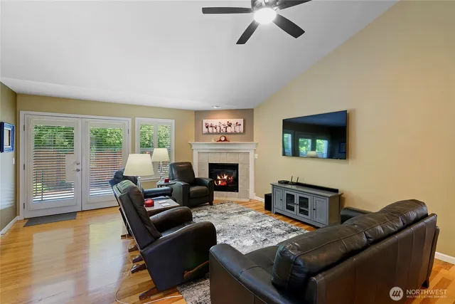 a living room with furniture a flat screen tv and a fireplace