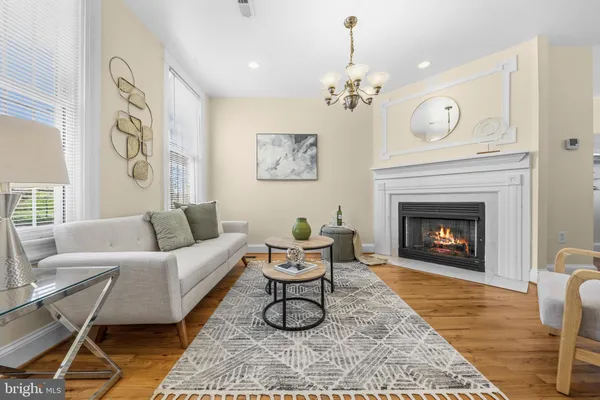 a living room with furniture a fireplace and a table