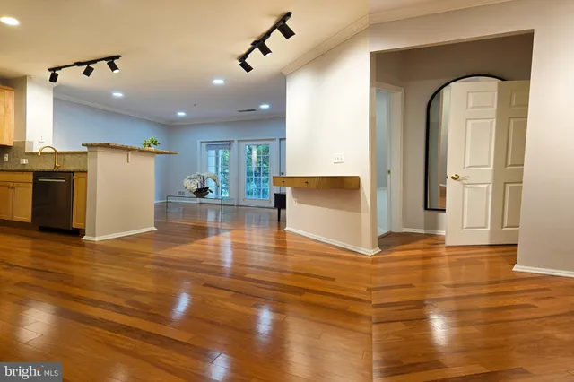 a view of kitchen and hall with wooden floor