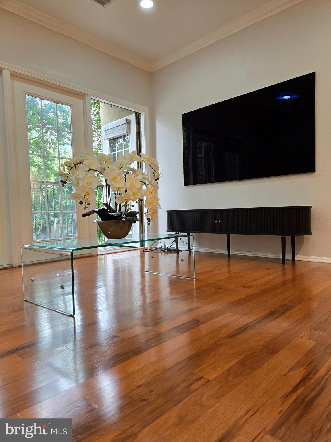 11800 Old Georgetown Road, Unit 1537 North Bethesda, MD 20852 - Photo 7 of 20 a living room with furniture wooden floor and a flat screen tv