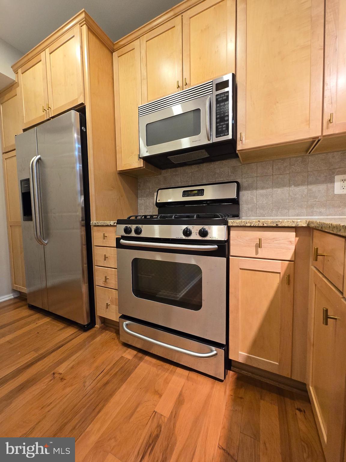 11800 Old Georgetown Road, Unit 1537 North Bethesda, MD 20852 - Photo 9 of 20 a kitchen with granite countertop wooden cabinets stainless steel appliances and a window