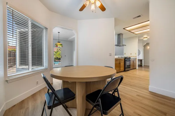 a view of a dining room with furniture and wooden floor