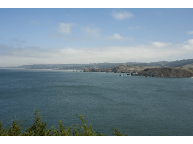 265 Kent Road Pacifica, CA 94044 - Photo 15 of 23 a view of an ocean beach and mountain