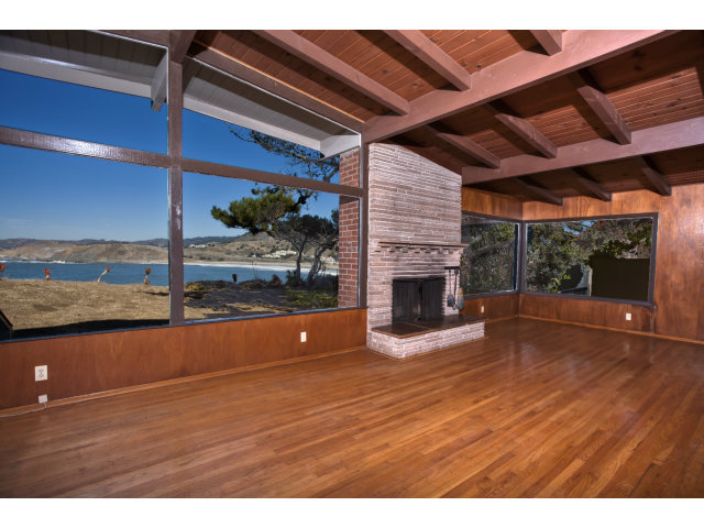 265 Kent Road Pacifica, CA 94044 - Photo 4 of 23 a view of an empty room with a fireplace and wooden floor