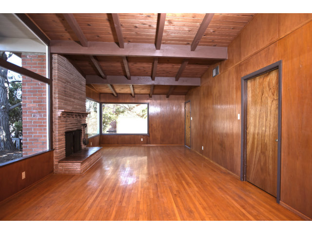 265 Kent Road Pacifica, CA 94044 - Photo 6 of 23 a view of an empty room with a fireplace and a window
