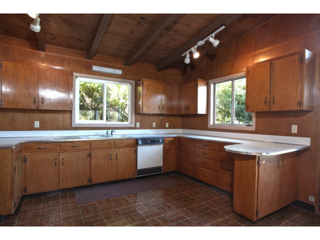 265 Kent Road Pacifica, CA 94044 - Photo 8 of 23 a kitchen with kitchen island granite countertop a sink window and cabinets