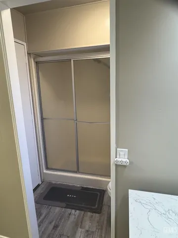 a spacious bathroom with a granite countertop sink and a mirror