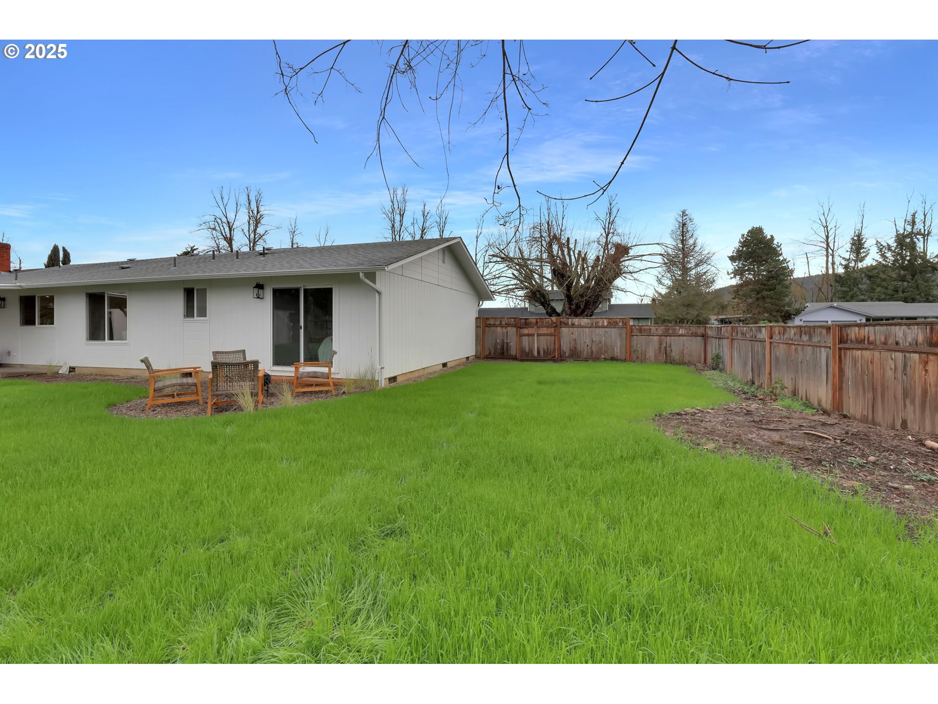 1090 Dixie Drive Springfield, OR 97478 - Photo 44 of 48 a view of a backyard with table and chairs under an umbrella