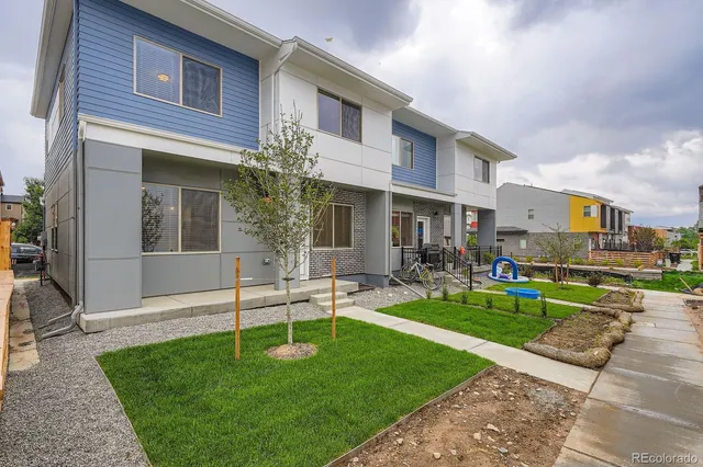 a front view of a house with a yard table and chairs