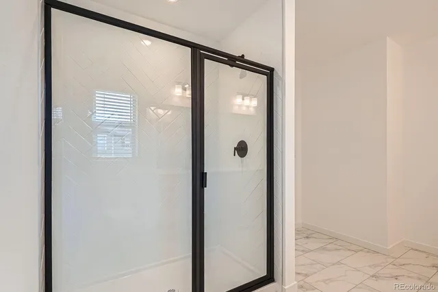 a bathroom with a glass shower door