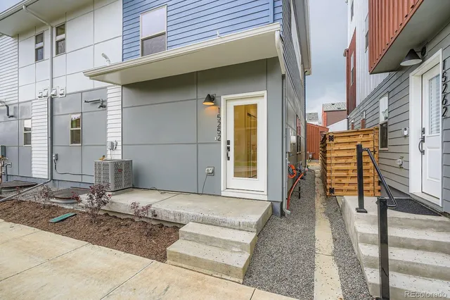 a view of a house with wooden door and furniture