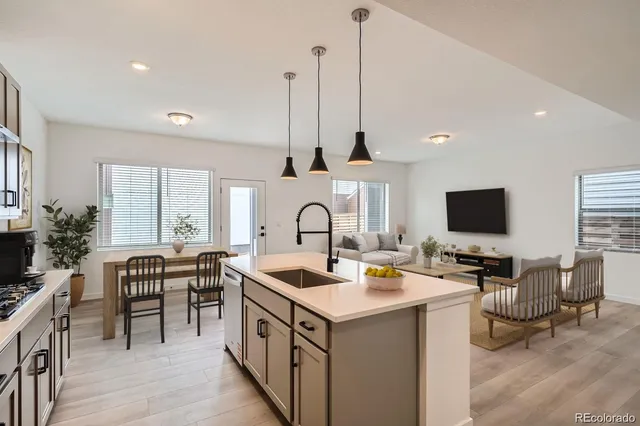 a open kitchen with stainless steel appliances granite countertop a sink and a wooden floors