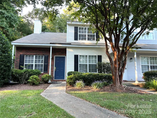 a front view of a house with garden and porch