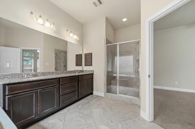 a bathroom with a granite countertop sink mirror and double