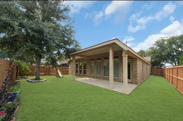a view of a house with a yard and sitting area