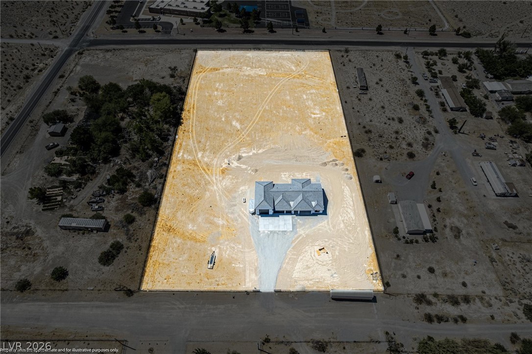 5910 East Kellogg Road Pahrump, NV 89061 - Photo 46 of 58 An aerial perspective reveals a newly constructed residence on an expansive, undeveloped lot.