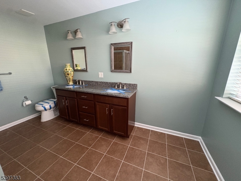 17 Alexanders Road Hackettstown, NJ 07840 - Photo 9 of 14 a room with a sink and a mirror