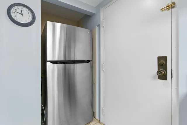 a bedroom with a bed and a lamp