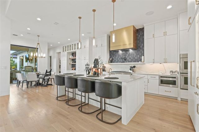 a large kitchen with lots of counter space and furniture