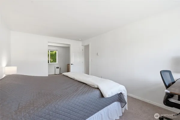 a bedroom with a bed and a chair