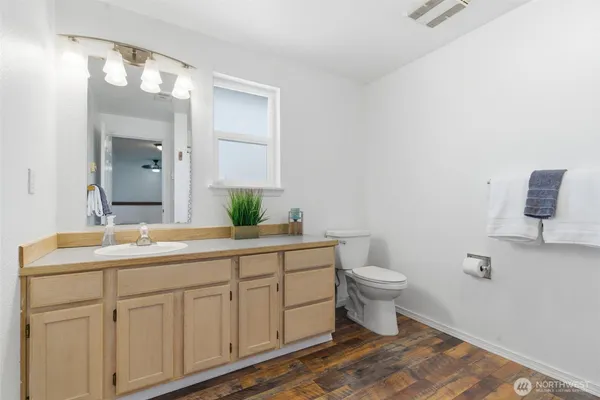 a bathroom with a double vanity sink and a toilet