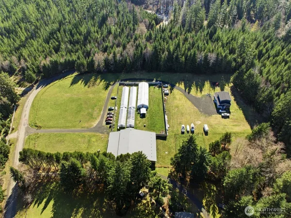 an aerial view of a house with a yard and greenery space