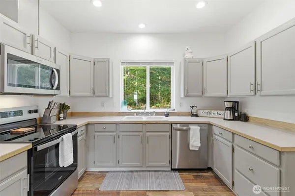 a kitchen with a sink stove and microwave