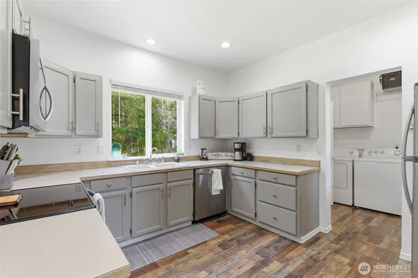 a kitchen with sink cabinets and window