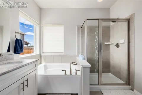 a bathroom with a bathtub and a shower
