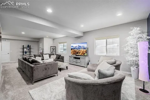 a living room with couch and a potted plant