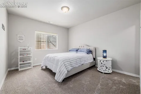 a bedroom with a bed and a desk