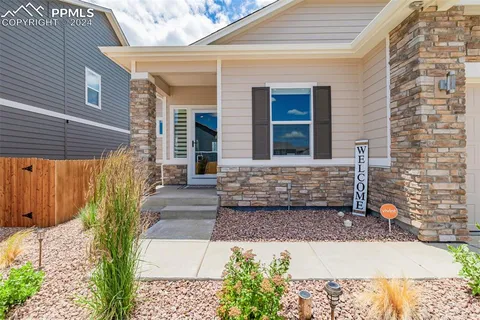 a front view of a house with garden