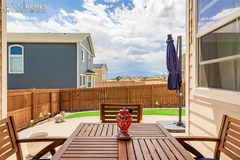 a front view of a house with garden and patio