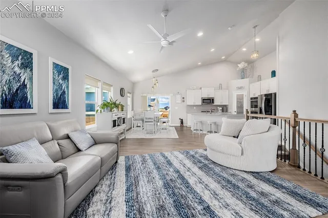 a living room with furniture or kitchen view and a wooden floor