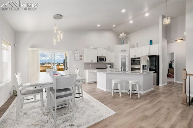 a living room with stainless steel appliances kitchen island furniture and a view of kitchen