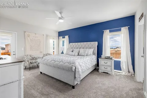 a spacious bedroom with a bed and a window