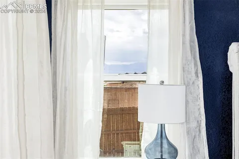 a bathroom with a light fixture next to a window