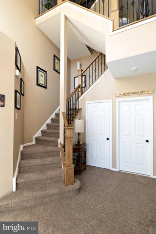 a living room with furniture a fireplace and a mirror